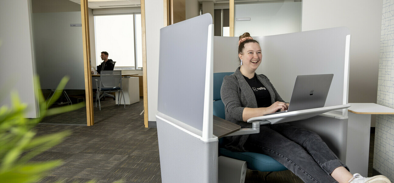 a photo inside the Box Clever office with a female staff member smiling from in a chair 