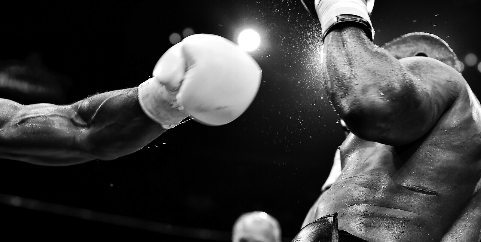 black and white photo of a boxing glove after landing a punch